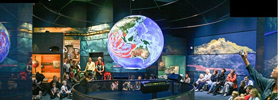 Visitors experiencing the Science on a Sphere immersive science facility